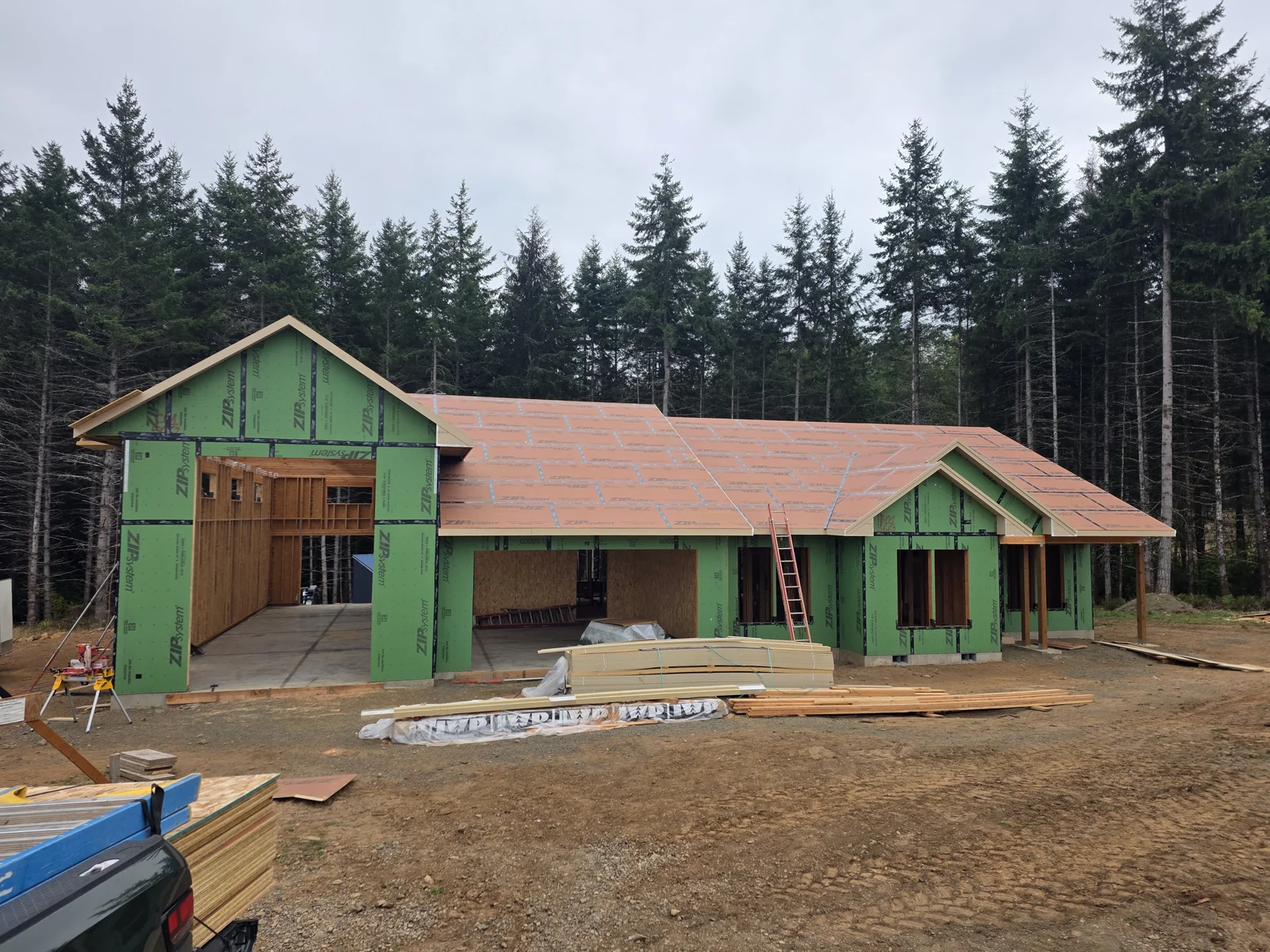 Original photograph of the home with roof sheathing and unfinished exterior walls